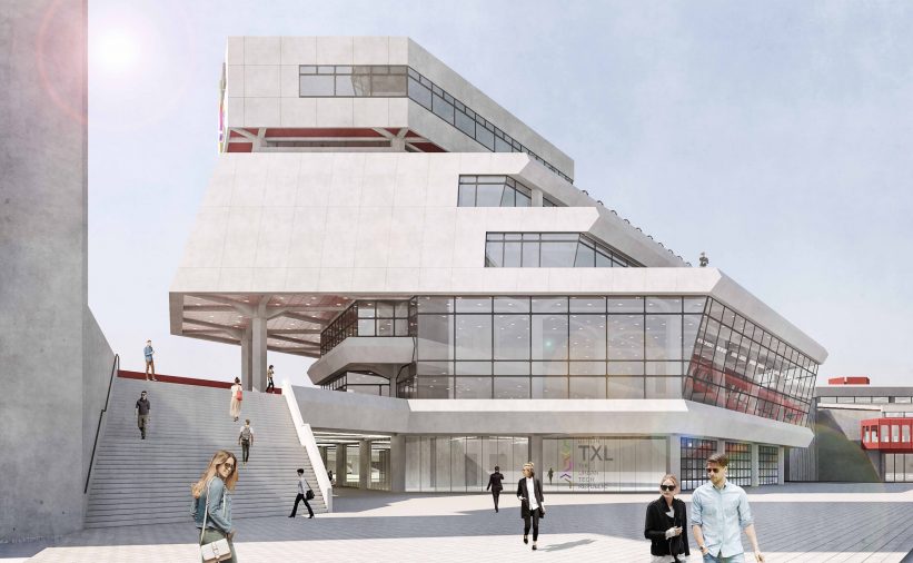 People walking in front of modern terminal buildin with glass front.